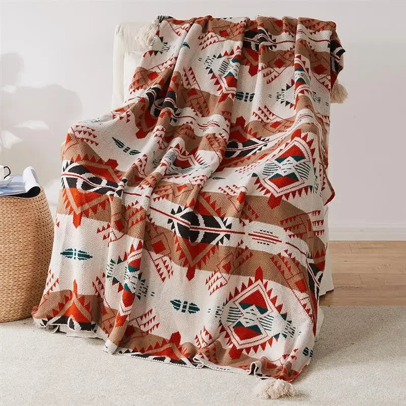 plaid tricoté bohème motifs géométriques avec pompons doux