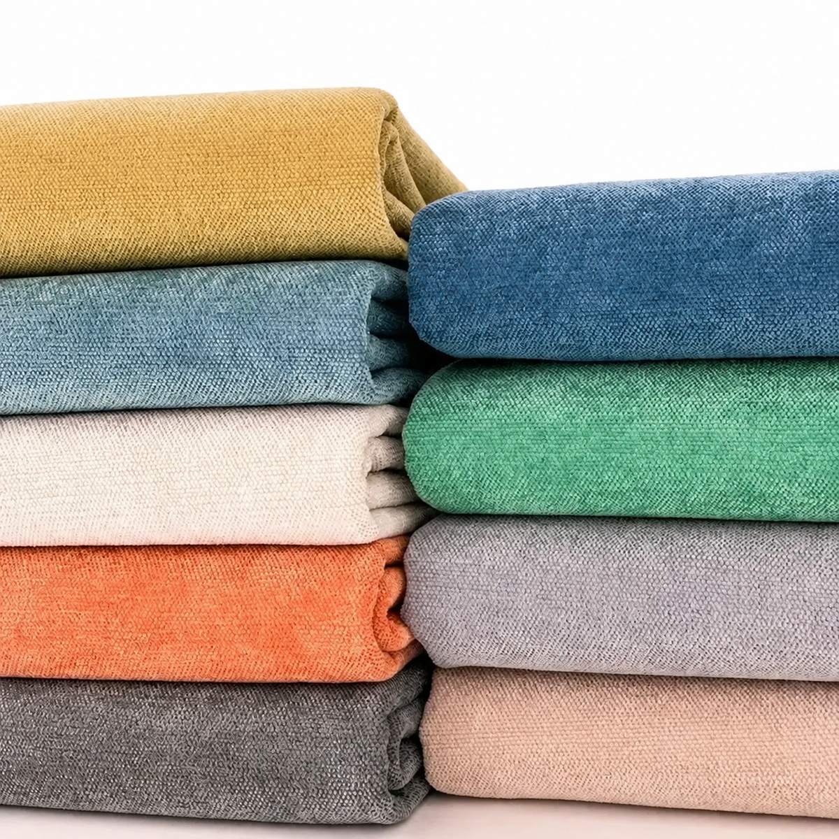 Tissus chenille de neuf coloris pliés en deux piles sur fond blanc