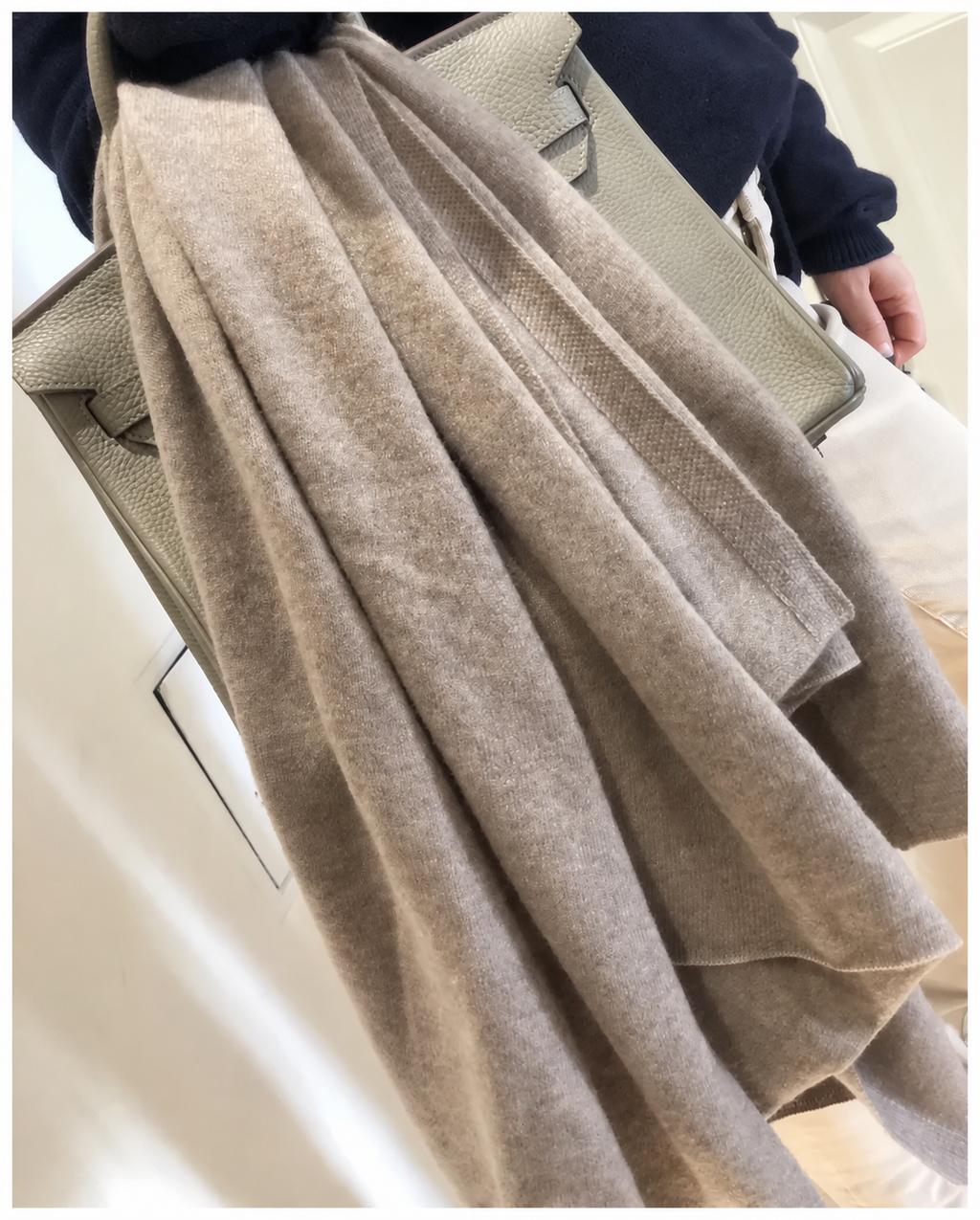 Écharpe taupe à maille fine portée avec un sac beige